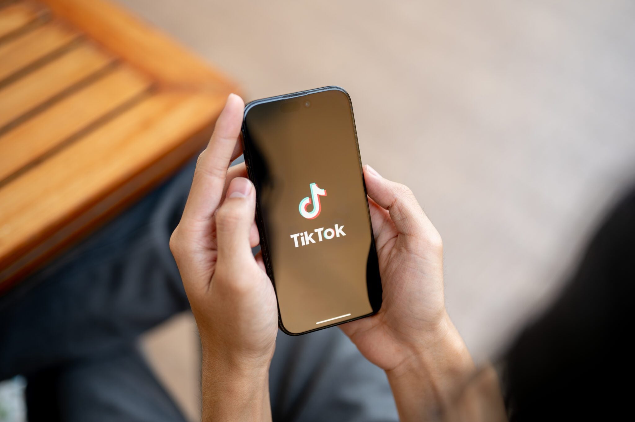Patient watching a dental practice's TikTok video on her phone before booking an appointment